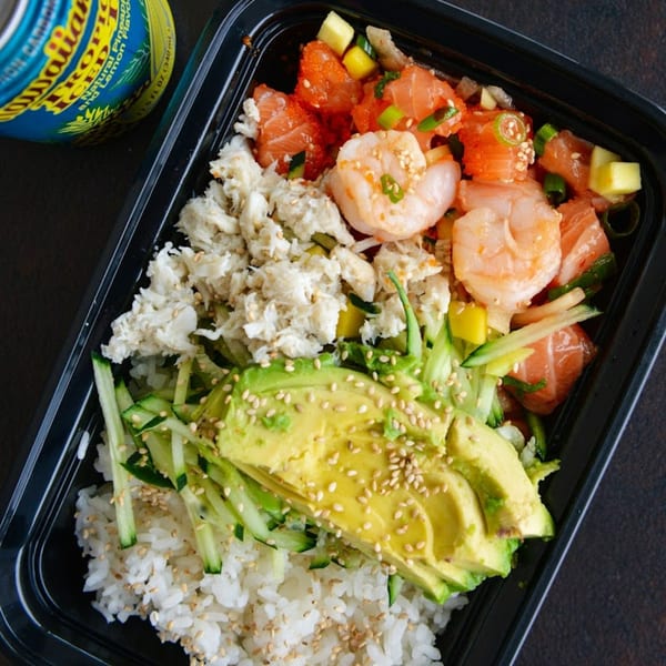 Tiger Plate poke bowl with rice, avocado, crab, shrimp, salmon, and a Hawaiian Sun drink.
