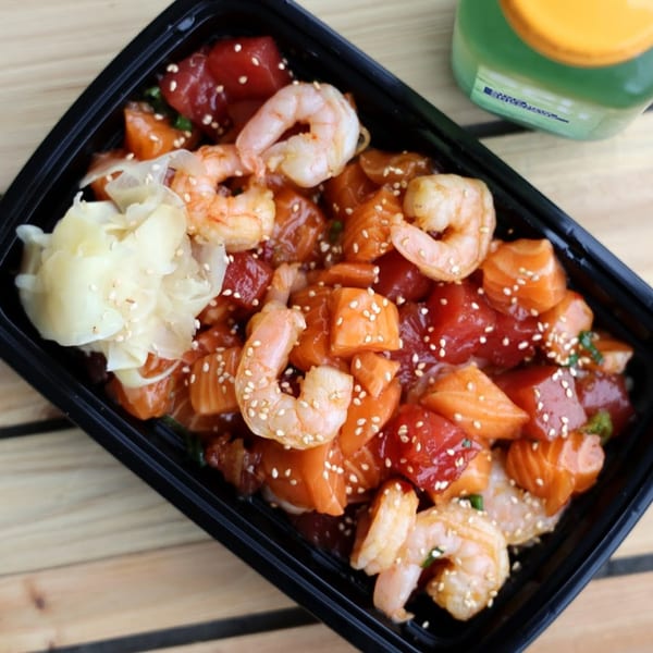 Tiger Plate poke bowl with salmon, tuna, shrimp, pickled ginger, and sesame seeds.