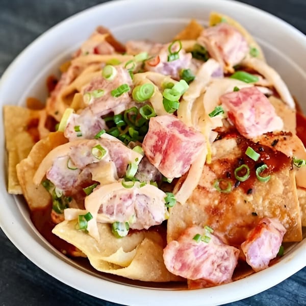 Tiger Plate's poke nachos with diced tuna, creamy sauce, and green onions on crispy wonton chips.