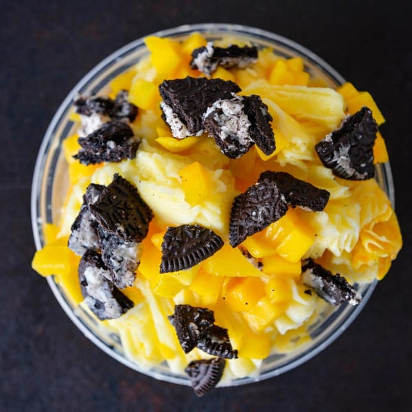 Tiger Plate's mango dessert with diced mangoes, shaved ice, and crushed Oreo cookies in a clear bowl.